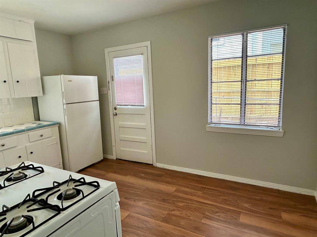 Eat-in area of kitchen with side door to driveway.