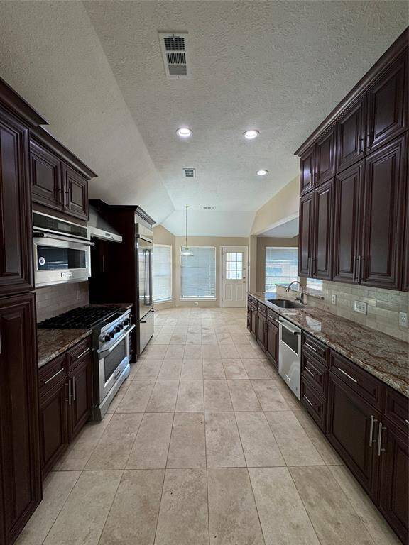 Kitchen with commercial grade fridge