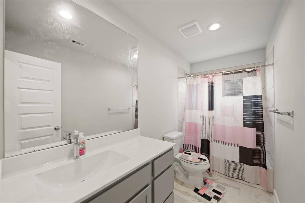 This secondary bath also features a spacious dual vanity, making busy mornings a breeze for the whole family.