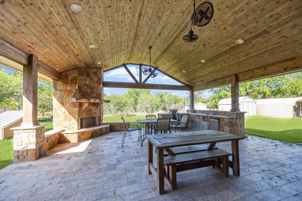 Covered patio with outdoor kitchen and fireplace!