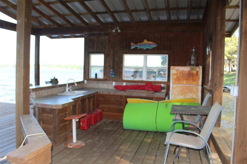 Outdoor Kitchen in the boat house complete with sink, electric cook top and frig. Let the good times float!!