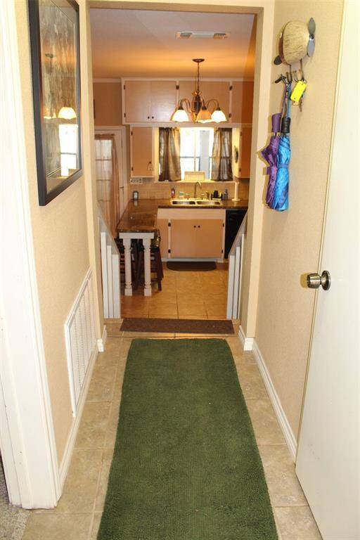 Let's take a look inside. You will see the uniqueness and character of this home right from the start.Upon entrance there is the guest bathroom to your right and a guest bedroom to your left.