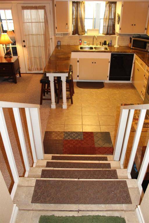 As you move forward you will step down into the open concept, kitchen and living room , which opens onto the amazing sunroom.