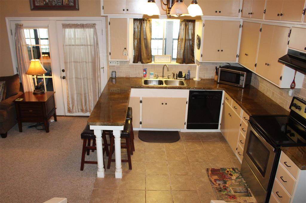 From the kitchen window you can take in the lake views with a nice bar setting area.