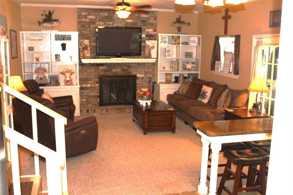 Relax after a full day in this cozy but open living area. Winters at the lake will be toasty by the glow of a warm fire here.