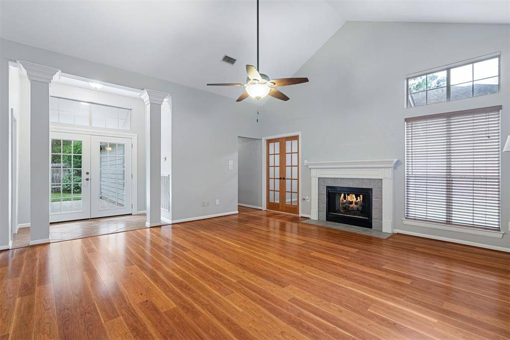 Great room features vaulted ceiling, architecturalcolumns, gaslog fireplace and laminate wood floors.Double doors to the left of fireplace open to study,which could also be used as a 4th bedroom. French doors behind columns open to back patio.