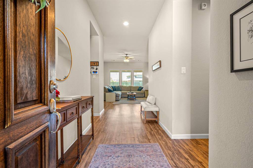 Welcome to an inviting foyer seamlessly leading into the bright, open living space.