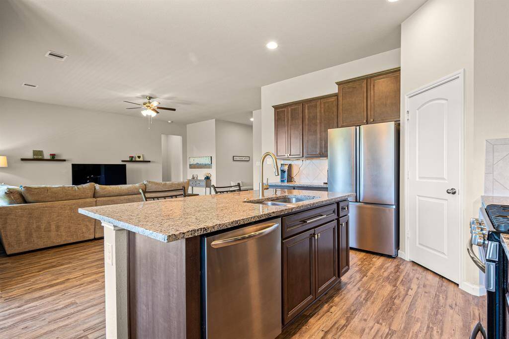 Spacious kitchen with modern stainless steel appliances and a sleek island, perfect for entertaining.