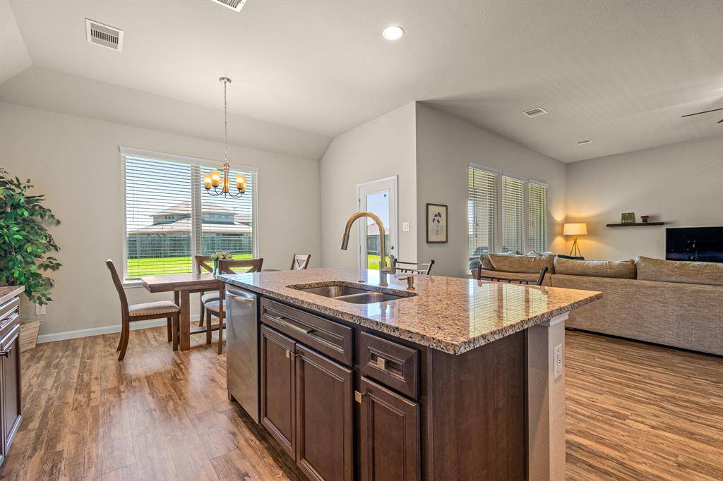 Spacious kitchen with a sleek island, open layout, and abundant natural light.