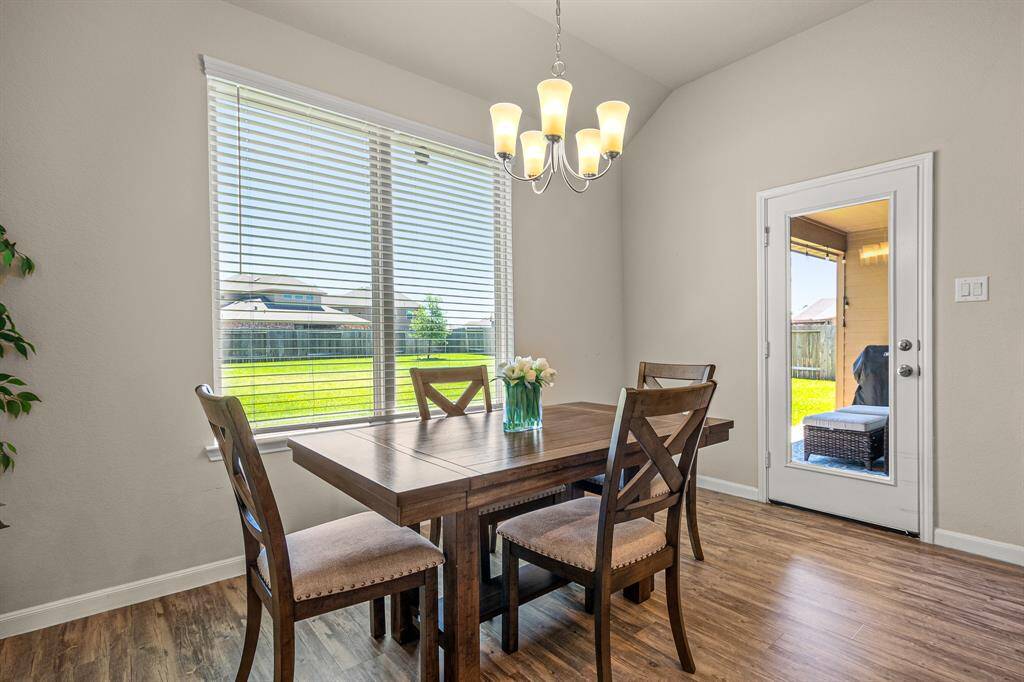 Cozy breakfast nook with abundant natural light and serene backyard views.