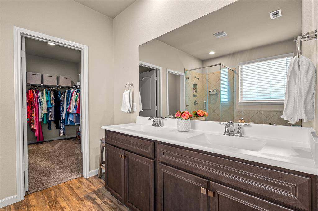 Elegant primary ensuite with direct access to a spacious walk-in closet.