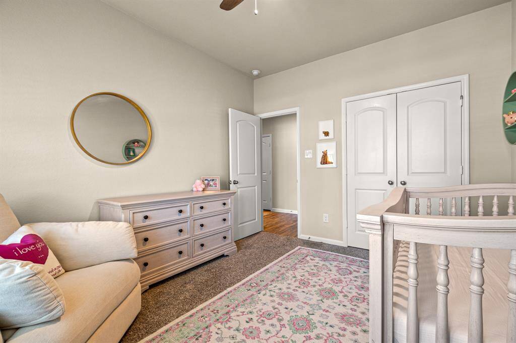 Charming guest bedroom with ample natural light, ideal for relaxation.