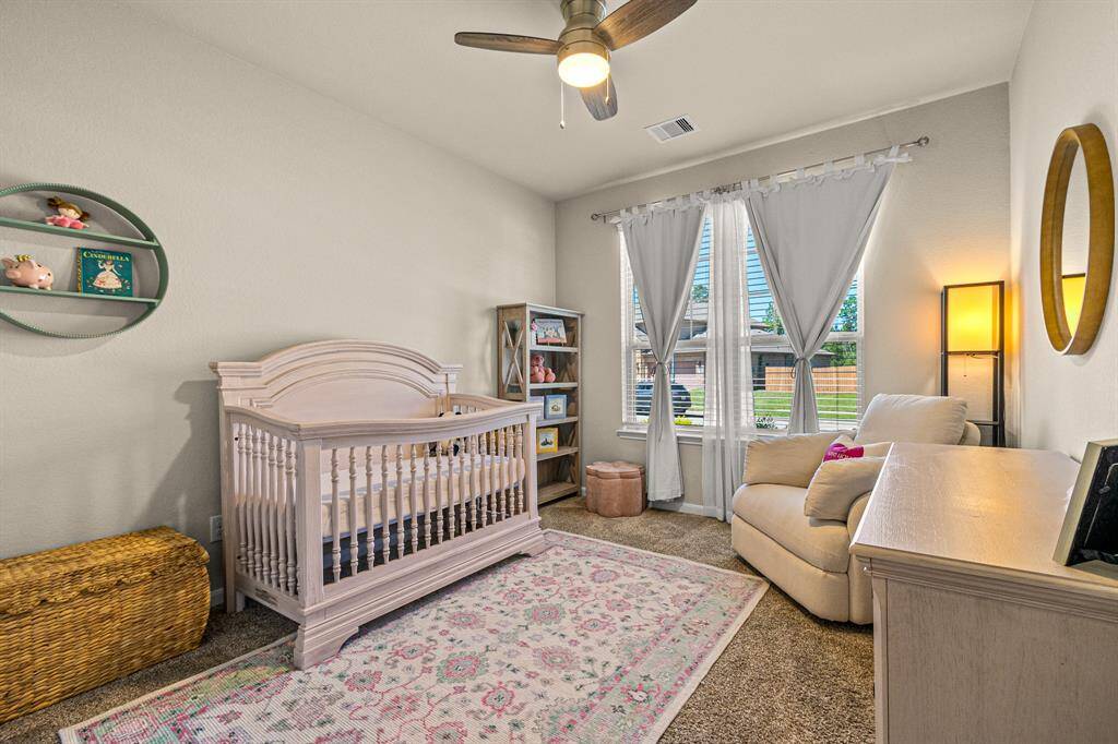 Cozy second guest bedroom with ample natural light and versatile space.