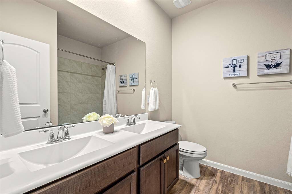 Spacious secondary bathroom featuring elegant double sinks.