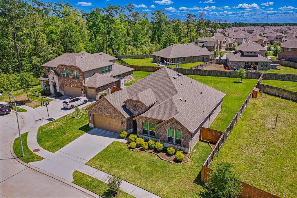 A stunning aerial view showcases this home, highlighting its spacious yard, charming curb appeal, and beautiful surroundings in a desirable neighborhood.
