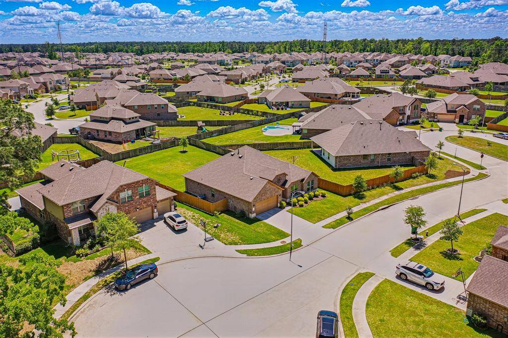 Explore a stunning aerial perspective of the home, highlighting its spacious lot and beautifully landscaped surroundings.