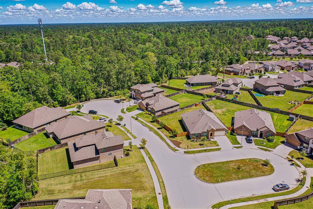 Discover a stunning aerial perspective of this spacious lot and charming home, nestled in a picturesque neighborhood.