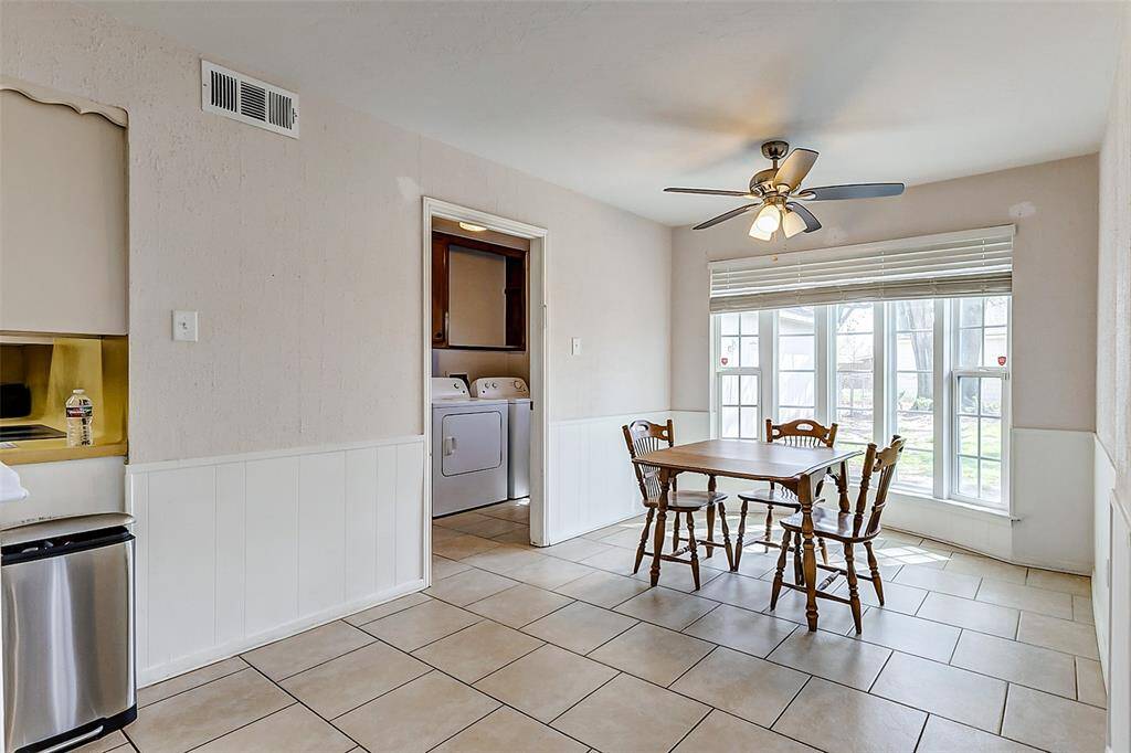 Continuing from the kitchen, you'll find the breakfast room that is spacious enough to accommodate a full dining table, allowing the formal dining room to serve as a flexible office space. A wall of windows floods the room with natural light and offers picturesque views of the backyard.