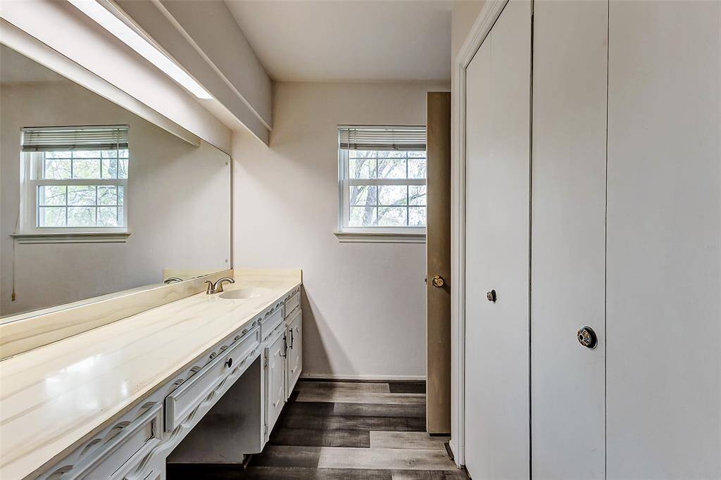The primary bath features a spacious vanity with a built-in seating area, an abundance of cabinetry, and much more, providing both functionality and style.