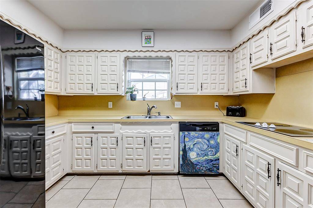 The heart of this home is the kitchen, ready to be transformed into your dream cooking space. The original solid wood cabinetry adds timeless charm, offering a great foundation for your vision.