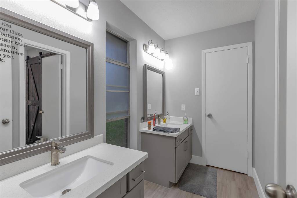 Sliding barn door leading into guest bathroom