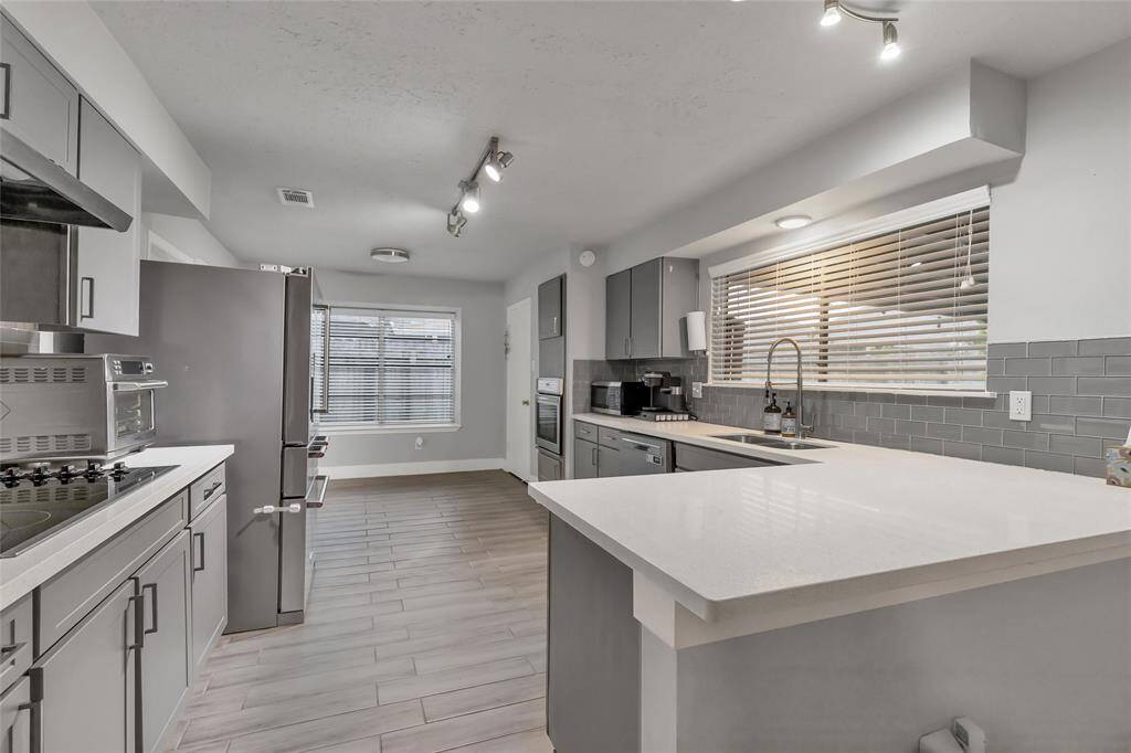 open concept kitchen & breakfast area with stainless steel appliances