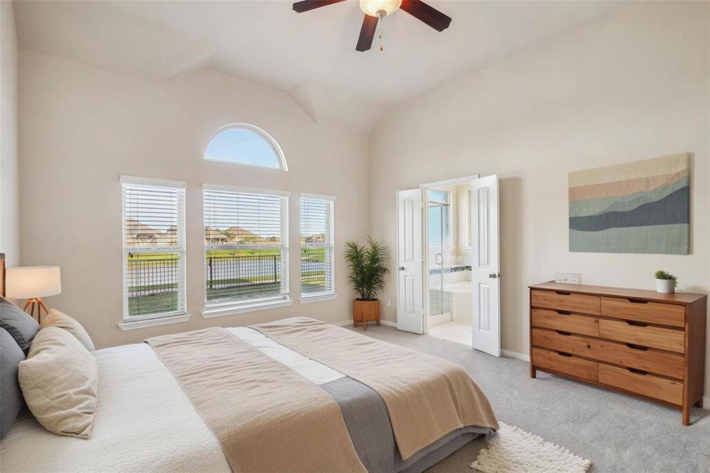 Primary bedroom with lake views! [virtuall staged]