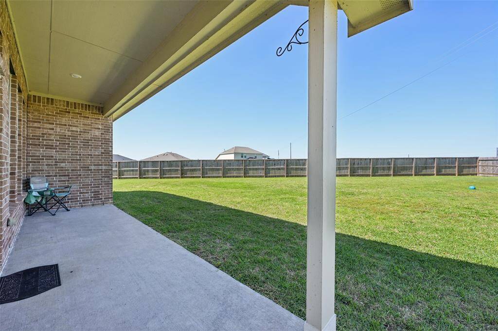 The back patio is a perfect space to enjoy the breeze and outdoor cooking.