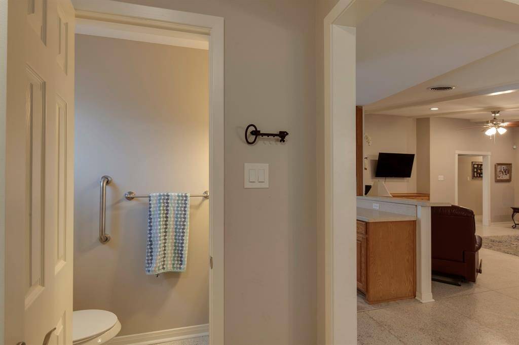 Half bath in utility room off the kitchen.