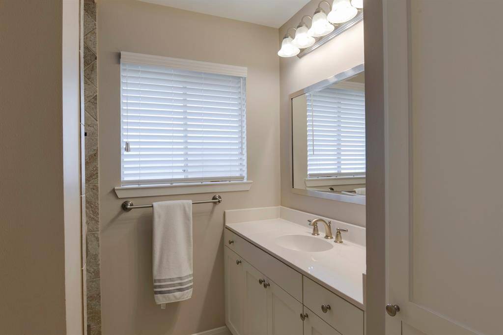 Primary bath has tile recently remodeled tile surround walk-in shower.