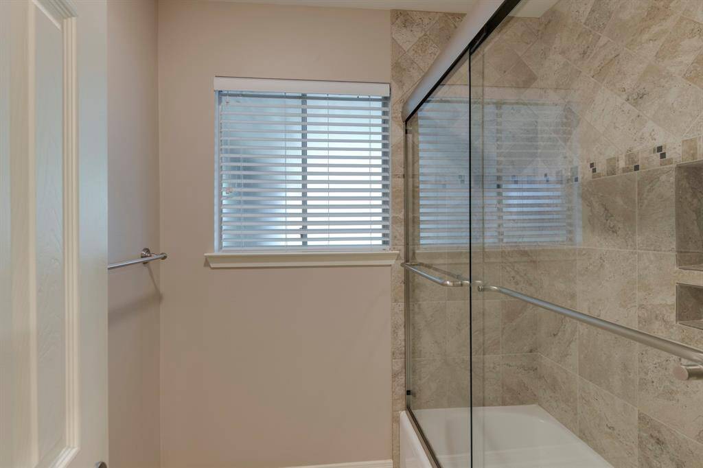 Recently remodeled secondary bath shower/tub with tile surround.