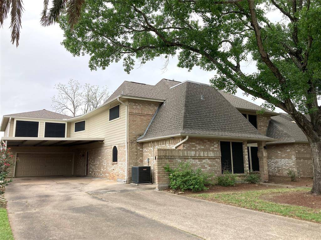 Front of the house and double wide driveway and carport.