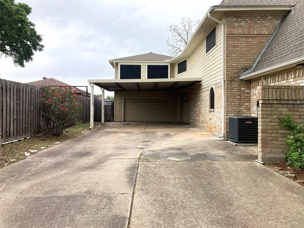 Double wide driveway and carport.