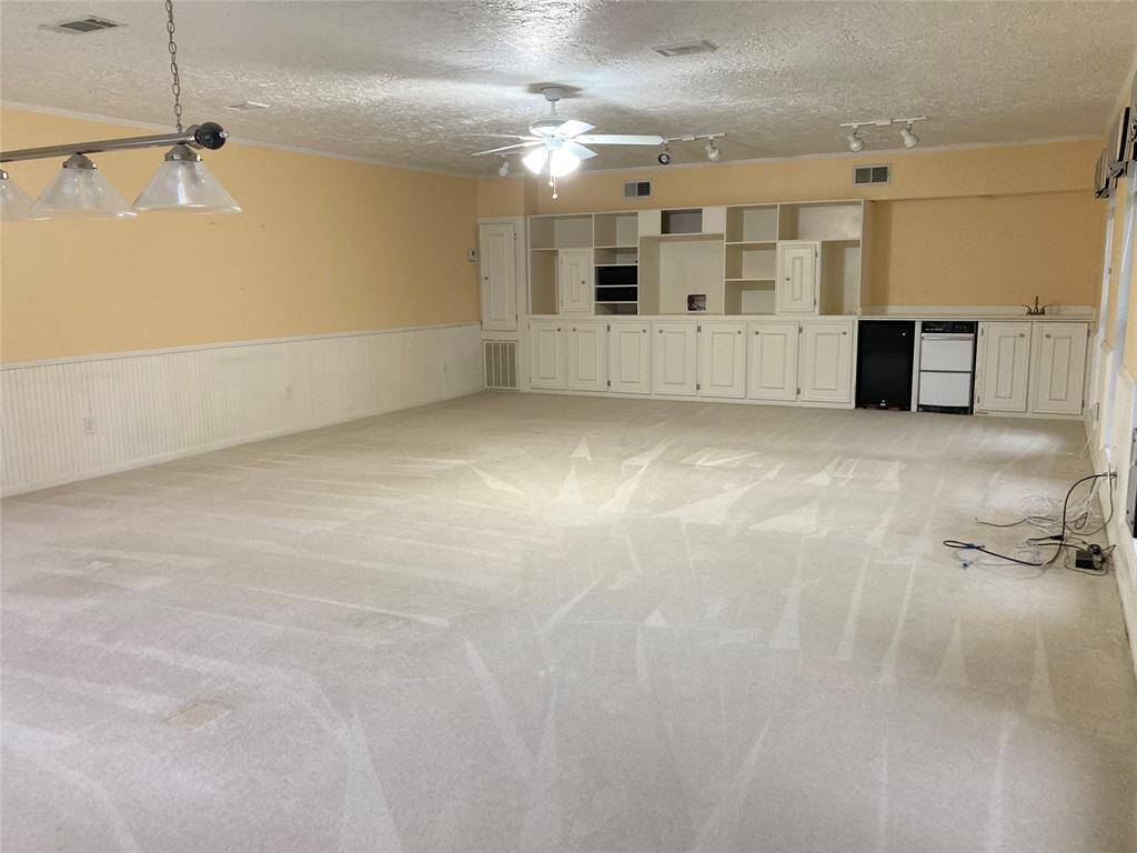 Enormous game room with built-ins and wet bar.