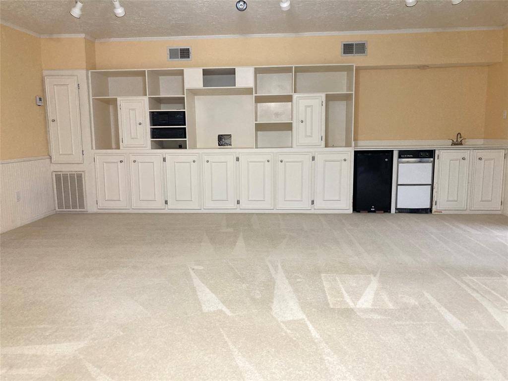 Enormous game room with built-ins and wet bar.