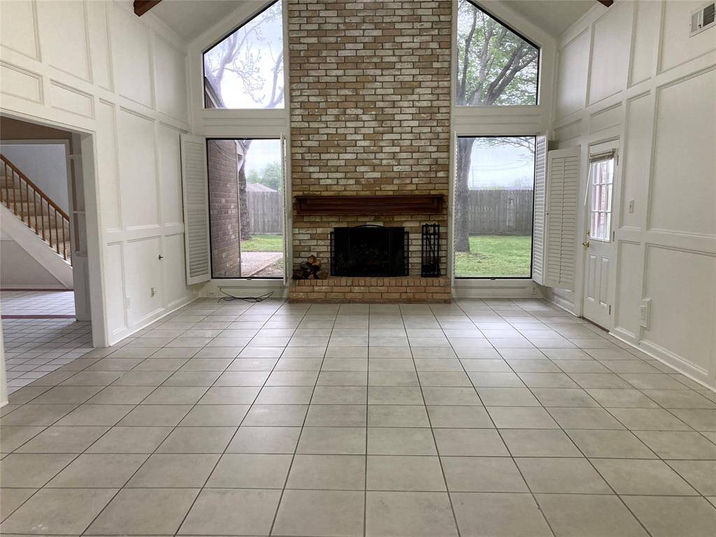 Massive living room with cathedral ceiling and fireplace.