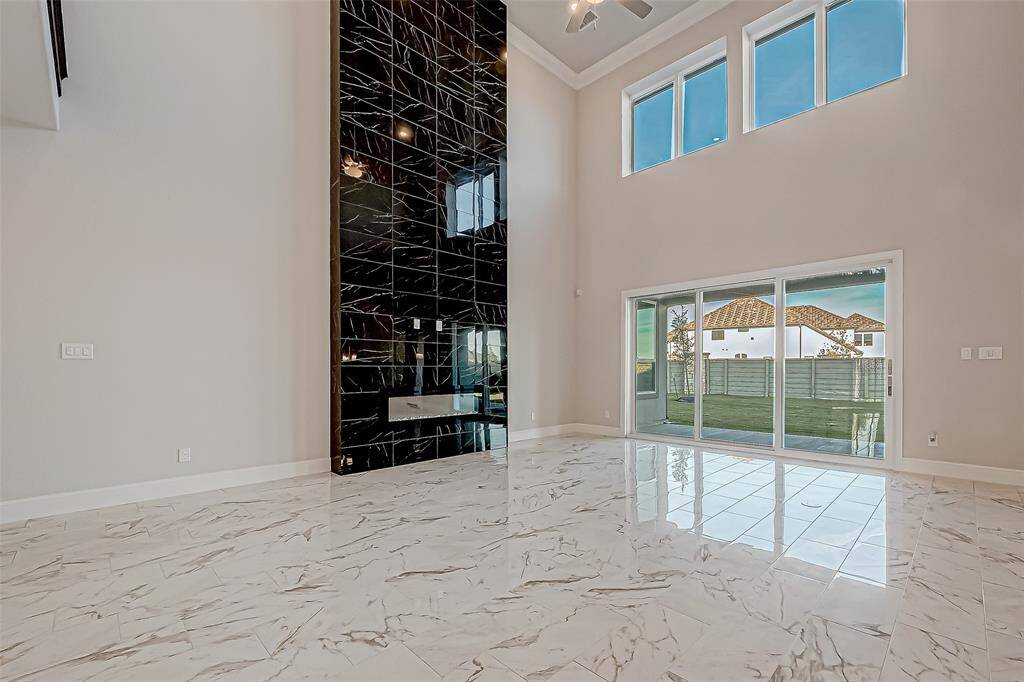 Sliding glass doors open to a covered backyard patio, seamlessly blending indoor and outdoor living.