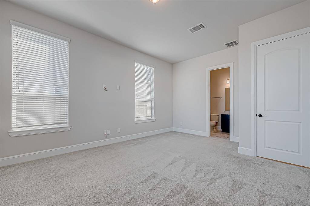 The second downstairs bedroom is a guest suite with a private bathroom and walk-in closet.