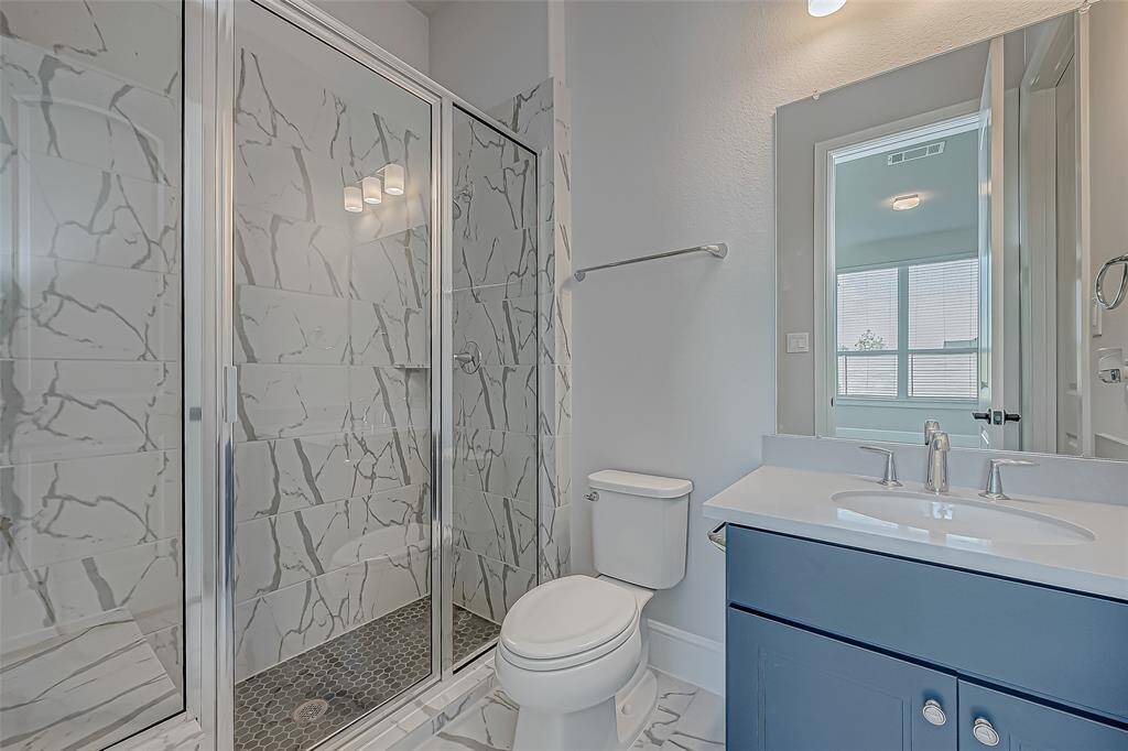 Upgraded shower with a seating bench.