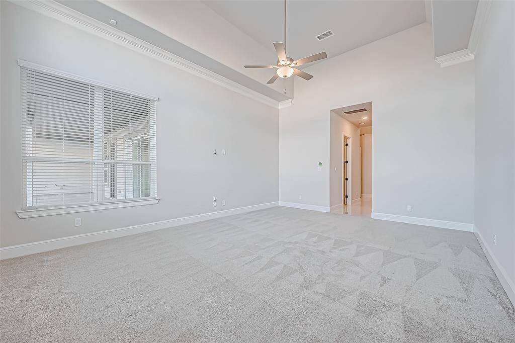 Primary with window view of backyard patio.