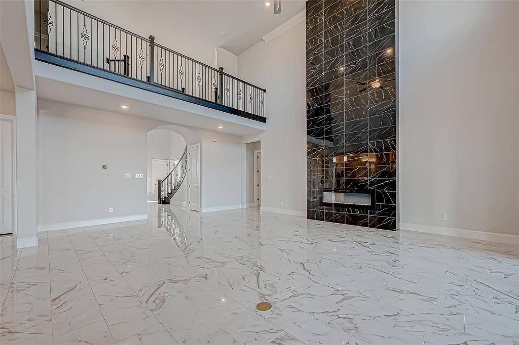 The home is pre-wired for sound, with recessed lighting and a balcony overlooking the space, further enhancing its charm.