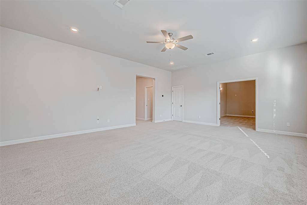 Upstairs, plush carpeting leads to a large game room with a closet and a media room pre-wired for sound.