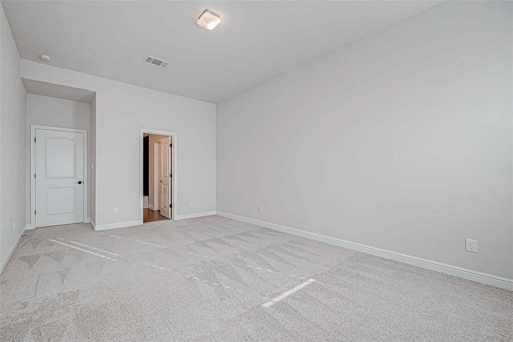 Two spacious secondary bedrooms, each with ensuite bathrooms and walk-in closets, provide comfort and privacy. (1 of 2 upstairs bedrooms)