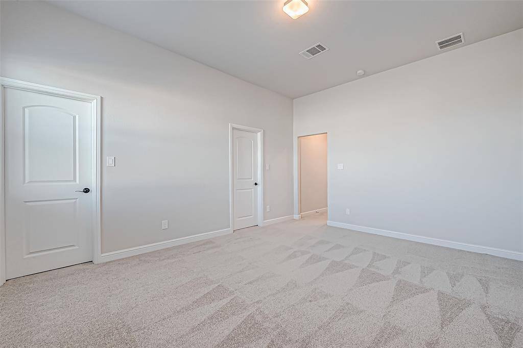 Two spacious secondary bedrooms, each with ensuite bathrooms and walk-in closets, provide comfort and privacy.(2 of 2 bedrooms)