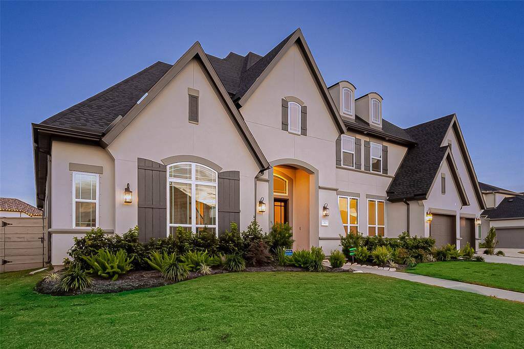 This property is a masterpiece of design and functionality, featuring 4 spacious bedrooms (2 Downstairs) The home boasts a fully stucco exterior, enhanced by an inviting covered porch entrance and elegant landscaping. A 4-car tandem garage with epoxy flooring and an automatic door opener ensures plenty of secure parking and storage space. Hurricane shutters add an extra layer of protection, while a full-zone sprinkler system keeps the yard lush and vibrant. The home is loaded with upgrades!!!