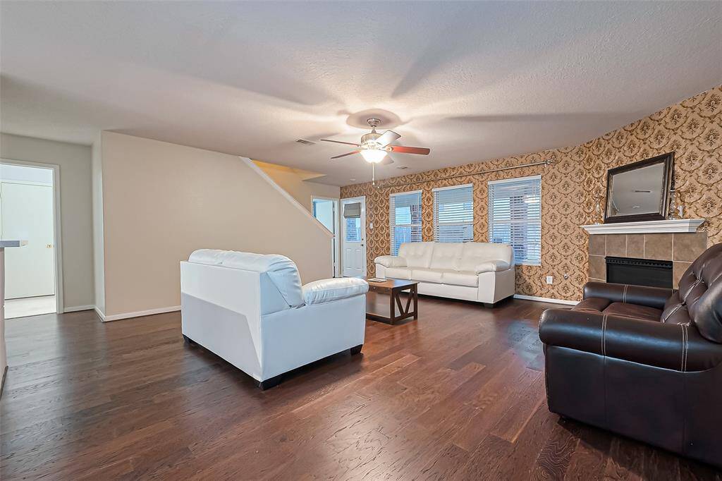 Large family room with warm wood flooring.