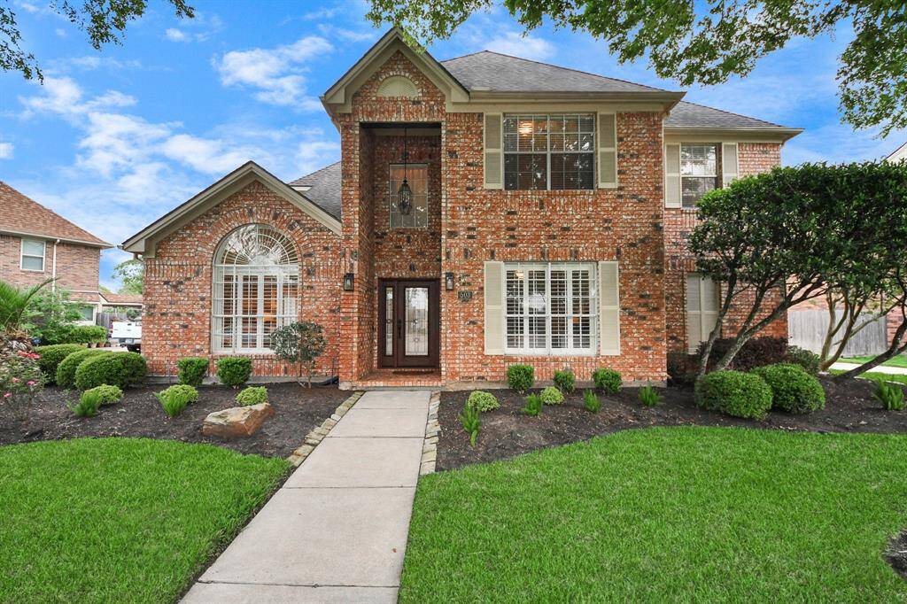 This stately two-story home, beautifully maintained and surrounded by rich landscaping, sits proudly on a spacious lot in the heart of Pecan Grove.
