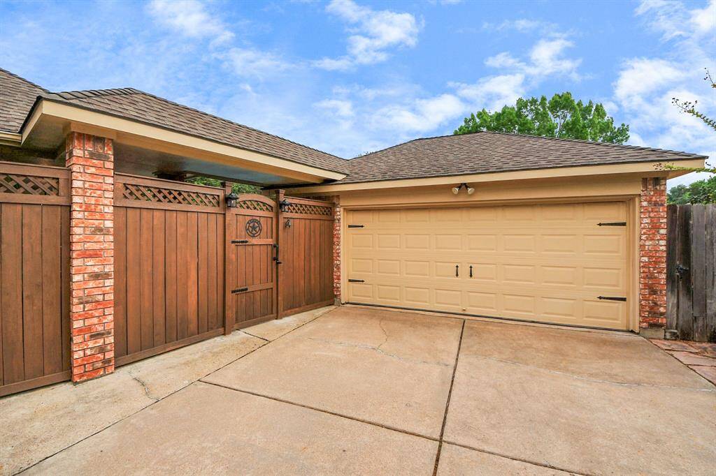 An oversized detached garage, fully finished, offers ample space for all your belongings. Tall fencing enhances privacy, creating a serene and secluded backyard.