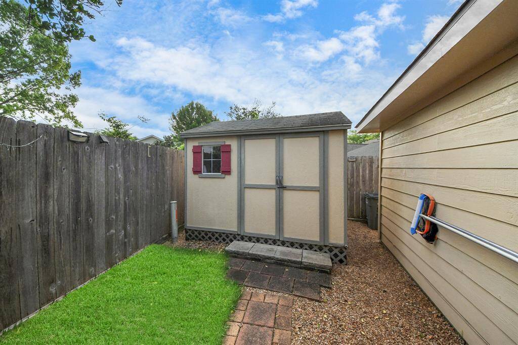 Behind the garage, a convenient storage building provides ample space to house your pool equipment and other yard essentials.