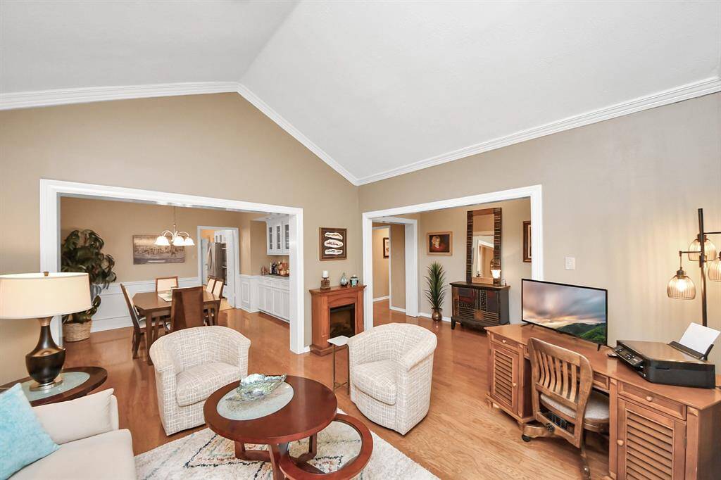 The living room flows seamlessly into the formal dining room, which sits just off the kitchen—perfectly designed for effortless entertaining.